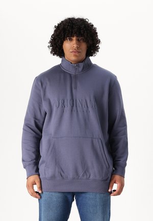 Purple pullover sweatshirt with a high collar, half-zip, front pocket, and embossed "ORIGINALS" text on the chest. Stretchy fabric.