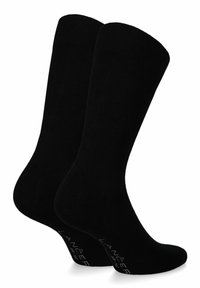 Czarne bawełniane skarpetki o gładkiej teksturze, do kolan, z wzmocnionymi palcami. Na podeszwie znajduje się logo w białym kolorze.