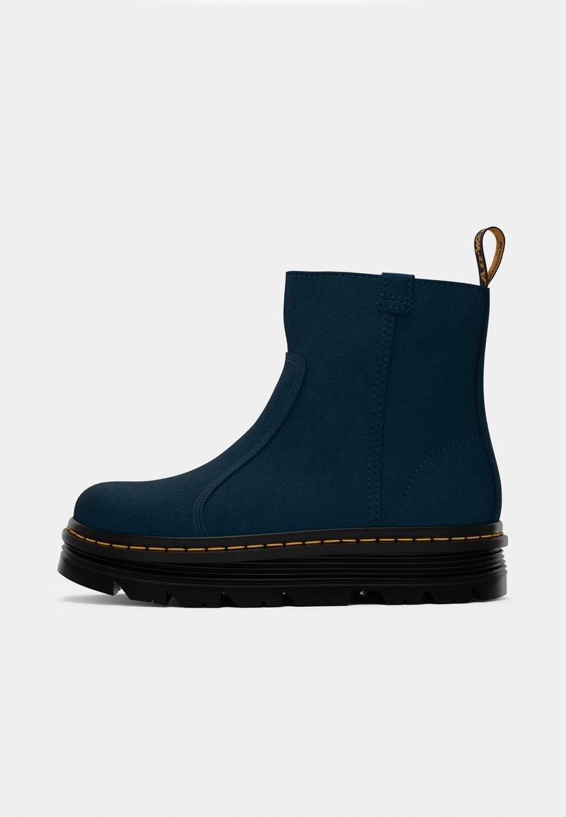 Bottines bleues en matériau lisse avec un côté élastique, semelle plateforme noire et couture jaune le long du bord. Tirant en boucle au talon.