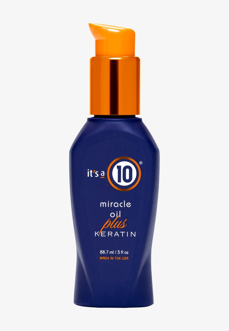Bouteille bleue avec pompe orange portant l'étiquette "it's a 10 miracle oil plus keratin", 88,7 ml, fabriquée aux États-Unis.