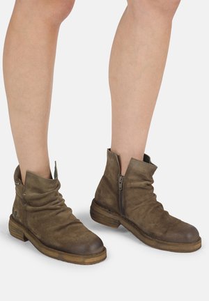 Botas de cuero marrón hasta el tobillo con un diseño arrugado, cremallera lateral, punta redondeada y tacón de madera apilada. Textura suave y acabado mate.