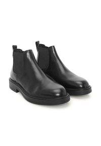 Botas Chelsea de cuero negro con paneles laterales elásticos, punta redonda y un tacón bajo. Textura suave y diseño minimalista.