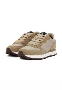 Beige sneakers made of suede and mesh, featuring a cream midsole, dark brown outsole, and a pink logo accent on the side.