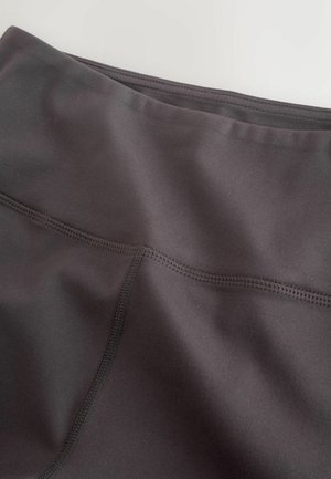 Black athletic leggings with a smooth, matte texture. Features a wide waistband and flat-lock seams for comfort and durability.