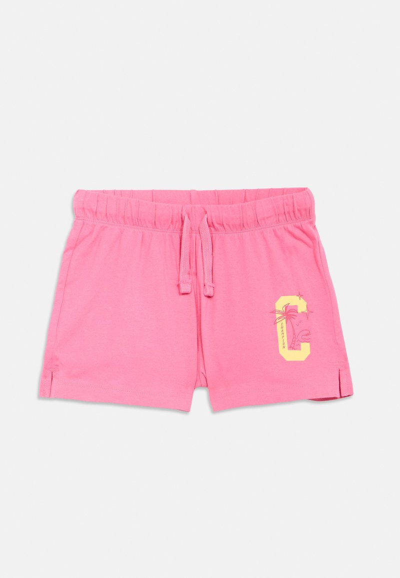 Shorts en coton rose avec une ceinture élastique, un cordon de serrage, des fentes latérales, et un motif graphique jaune représentant un palmier et la lettre "C".