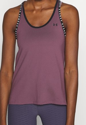 Paarse sport tanktop met zwarte afwerking en banden met "Under Armour" branding. Gladde textuur, mouwloos ontwerp en relaxte pasvorm.