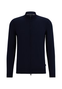 Laivastonsininen vetoketjullinen neuletakki, jossa korkea kaulus, pitkät hihat, resorireunukset hihansuissa ja helmassa, valmistettu sileästä, pehmeästä kankaasta. Ei näkyviä kuvioita tai koristeita.