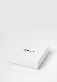 Weiße rechteckige Box mit glatter Oberfläche, die oben in der Mitte ein schwarzes "CHRIST est. 1861"-Logo zeigt. Einfaches Design, keine sichtbaren Verzierungen.