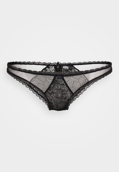 Svart blonde thong med blomster mønster, semi-gjennomsiktig front, bølgete kanter, og en liten metall merke logo midt bak.