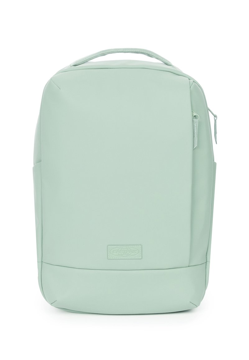 Light green backpack made of smooth, flexible material. Features a zippered front pocket, top handle, and rectangular shape.