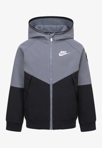 Grijze en zwarte zip-up hoodie met een contrastontwerp, voorzien van een Nike-logo, zijzakken en elastische manchetten. Zacht materiaal met een capuchon.