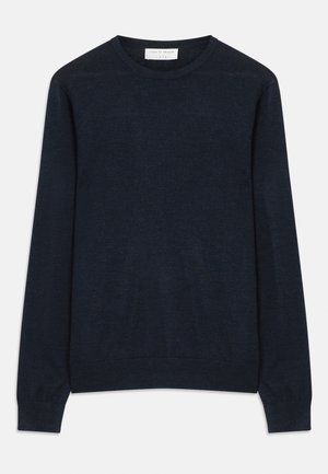 Navy blue crewneck sweater made of soft fabric. Features long sleeves and ribbed cuffs and hem. Simple, solid color with no patterns.