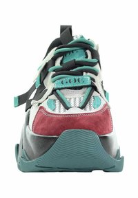 Masywne sneakersy w kolorach turkusowym, czarnym, białym i bordowym, z turkusowymi i czarnymi sznurówkami oraz wzorzystą turkusową gumową podeszwą.