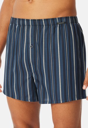 Donkerblauwe boxershort met verticale strepen in tinten blauw en grijs; elastische tailleband met een knoopsluiting; zachte stoftextuur.