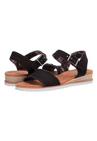 Zwarte sandalen met bandontwerp, zachte suede materiaal, verstelbare gesp, geweven espadrille-wedge en witte rubberen zool.