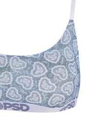 Lichtblauwe bralette met een bloemenpatroon en witte accenten. Gemaakt van zachte stof, heeft het een witte elastische band met "PSD" merknaam.