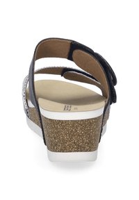 Zwarte lederen sandalen met kurken wiggenhak en witte zool. Voorzien van enkelbandjes, een gestructureerde binnenzool en decoratieve accenten op de bandjes.