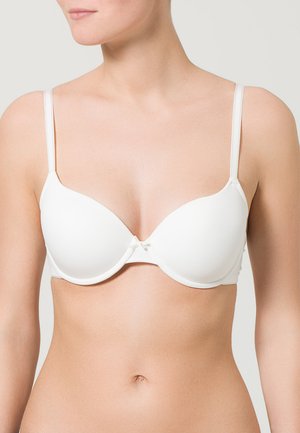Sostenitore bianco imbottito con spalline regolabili, tessuto liscio e dettaglio a fiocco al centro. Presenta un design senza cuciture per una vestibilità discreta.
