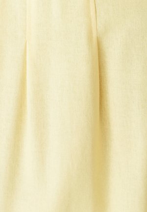 Hele kollane kangas pehme tekstuuriga, millel on vertikaalsed voltide lisadimensiooniks. Materjal näeb välja kerge ja õhuline.