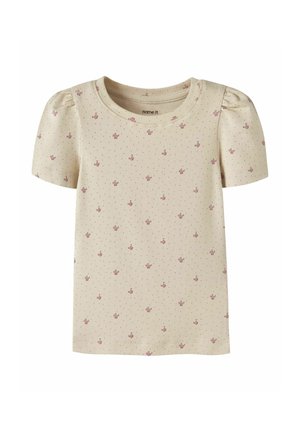Chemise crème manches courtes pour tout-petit avec petits motifs floraux roses et minuscules points noirs, avec un léger effet bouffant sur les manches.