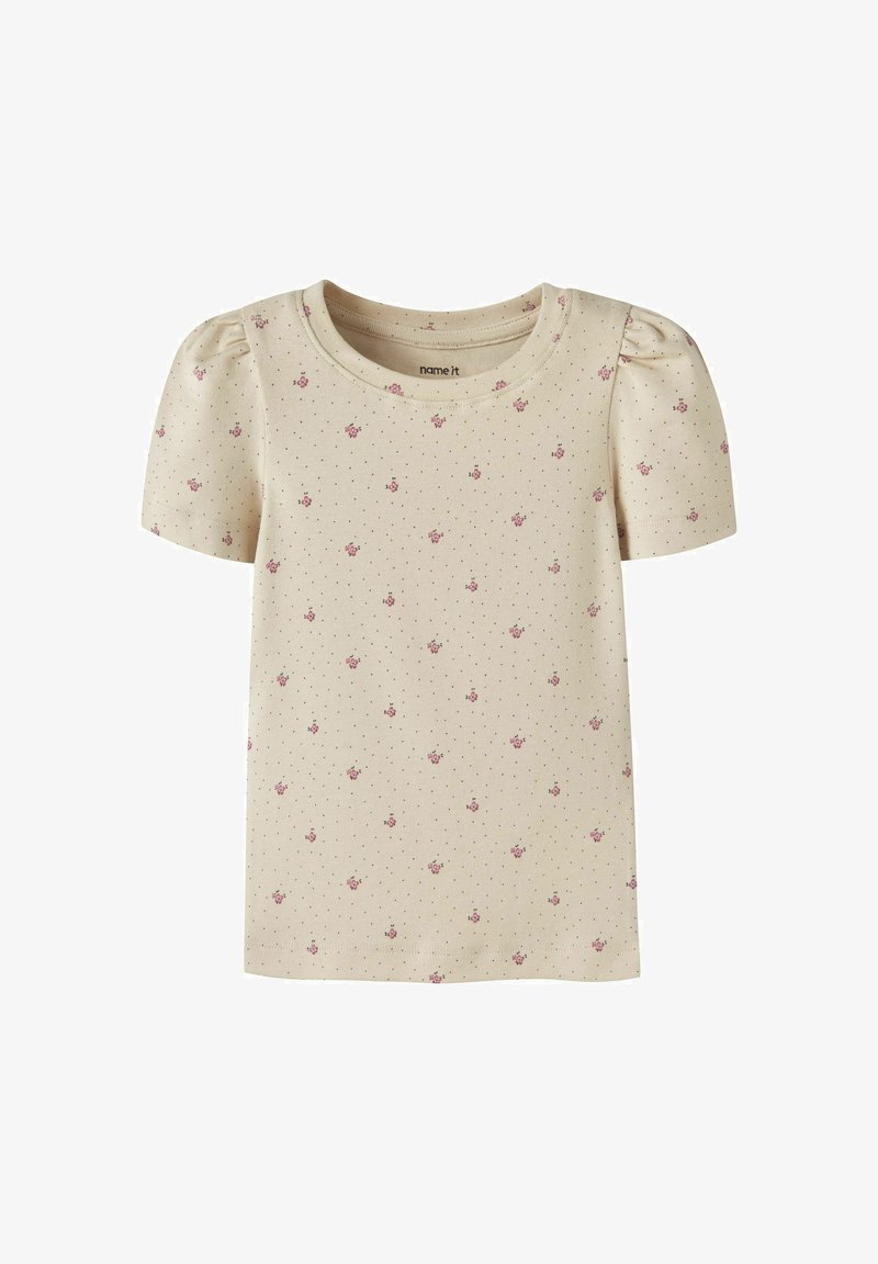 Chemise crème manches courtes pour tout-petit avec petits motifs floraux roses et minuscules points noirs, avec un léger effet bouffant sur les manches.