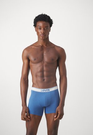 Modre bombažne bokserice z belim elastičnim pasom z znakoma "Levi's". Prilega obliko, gladka tekstura in dolžina do sredine stegna.