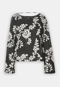 Musthave mustriibul varrukatel must T-särk valgete lillemotiividega, ümar krae, tekstureeritud kangas ja kastikesesiluett.