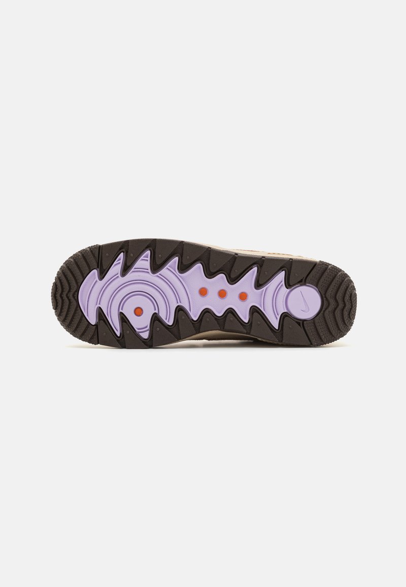 Suola di sneaker con una sezione esterna nera e testurizzata, un intersuola di un leggero viola con motivi circolari e tre punti rossi per aderenza e trazione.