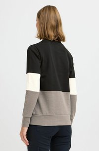 Felpa a blocchi di colore con pannelli neri, crema e grigi; morbido materiale in cotone; polsini e orlo a coste; design con collo rotondo.