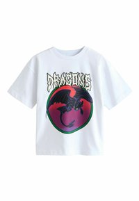 White cotton T-shirt featuring a circular graphic of a dragon in shades of black and purple, with the word "DRAGONS" in bold font above.