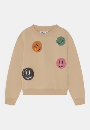 Beige sweatshirt med fire farverige paillet-smileyansigter i orange, grøn, pink og sort på forsiden.