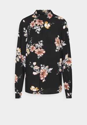 Blouse noire à manches longues avec col montant, imprimé floral rose, blanc et jaune, avec poignets et col smockés.