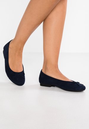 Ballet flats en daim bleu marine avec un petit nœud detailé à l'orteil, une forme arrondie et un petit talon en caoutchouc noir.