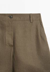 Brown linen pants with a button closure, belt loops, and visible side pocket stitching on a white background.