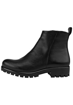 Bottine en cuir noir avec semelle à crampons, bout arrondi, fermeture éclair latérale et languette à l'arrière.
