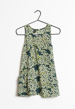 Sleeveless dark green dress with small yellow and white floral pattern, hanging on a black metal hanger against a white background.
