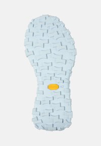 Suela Vibram en azul claro, con un patrón texturizado y rugoso que presenta profundos surcos para mayor tracción y una etiqueta amarilla con la talla 42.