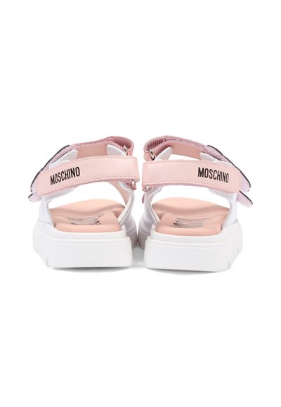 Różowo-białe sandały marki Moschino z grubymi białymi podeszwami, regulowanymi paskami z tyłu, widoczne od tyłu.