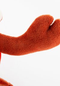 Orange plush toy arm with a soft, textured surface and rounded shape, featuring a slight curve at the end.