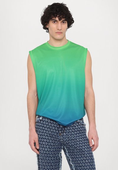 Green and blue gradient sleeveless top made of lightweight fabric, paired with blue textured pants featuring a frayed hem and patterned design.
