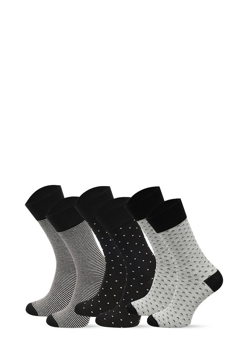 Zestaw czterech skarpetek: czarne w paski, jednolite czarne z białymi kropkami, szare z czarnymi wzorami oraz białe z czarnymi motywami. Wszystkie z czarnymi ściągaczami.