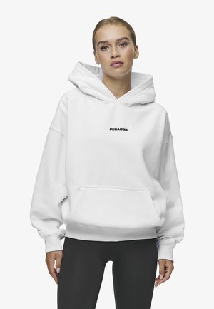 Witte oversized hoodie van zachte stof, met een voorkatel en een zwart logo "PEGADOR" in het midden van de borst.