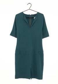 Tealfärgad klänning med korta ärmar, V-ringning och framficka. Slät tyg med minimalistisk design; har två framfickor och en dold dragkedja.