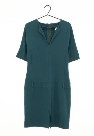 Robe turquoise à manches courtes, décolleté en V et fente avant. Tissu lisse avec un design minimaliste ; comporte deux poches avant et une fermeture éclair dissimulée.