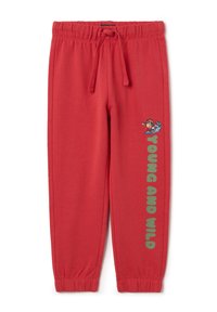 Red sweatpants made of soft fabric, featuring a drawstring waistband, elastic cuffs, and a colorful "Young and Wild" graphic on the side.