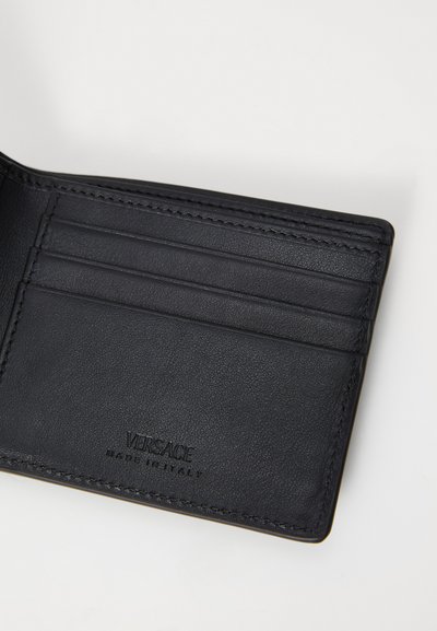 Black leather cardholder with smooth texture, featuring multiple card slots and embossed logo. Simple design, no additional hardware.