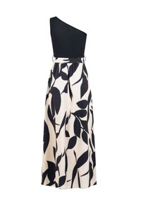 Robe longue sans manches noire et blanche avec corsage noir asymétrique et jupe fluide ornée de grands motifs de feuilles noires sur fond blanc.