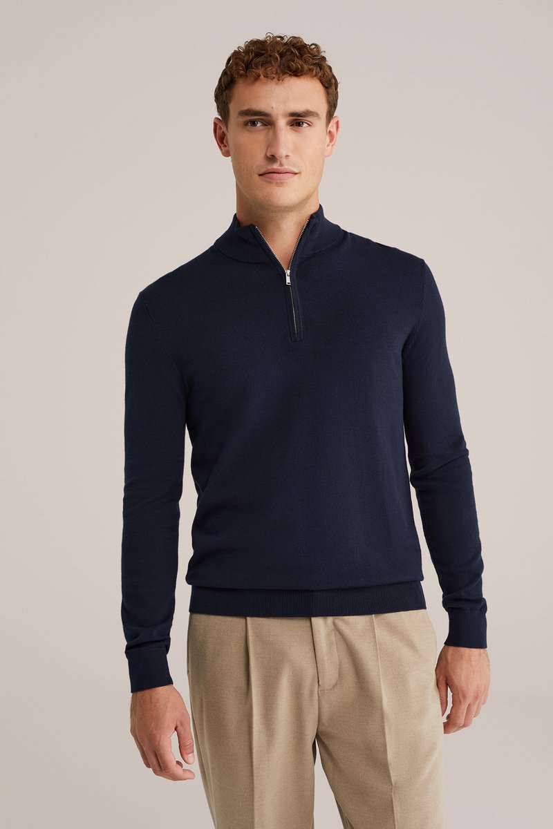 Sweater zip-up blu navy in un morbido materiale a maglia con polsini e orlo a costine. Presenta un colletto corto e una vestibilità affusolata.