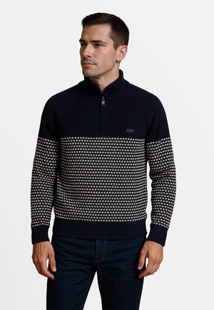 Marineblauwe pullover trui met half-rits kraag, voorzien van een crèmekleurig geometrisch patroon over de borst, geribbelde manchetten en zoom.