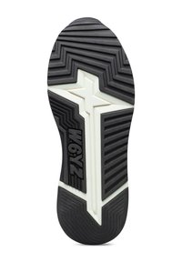 Suola della scarpa con un motivo geometrico in bianco e nero, caratterizzato da una forma a stella e il testo "W6YZ" impresso vicino all'arco.